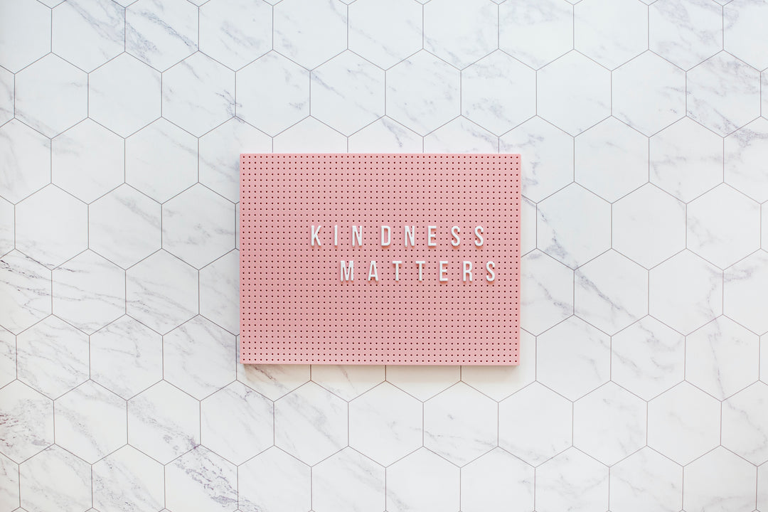 peg board with the word kindness matters